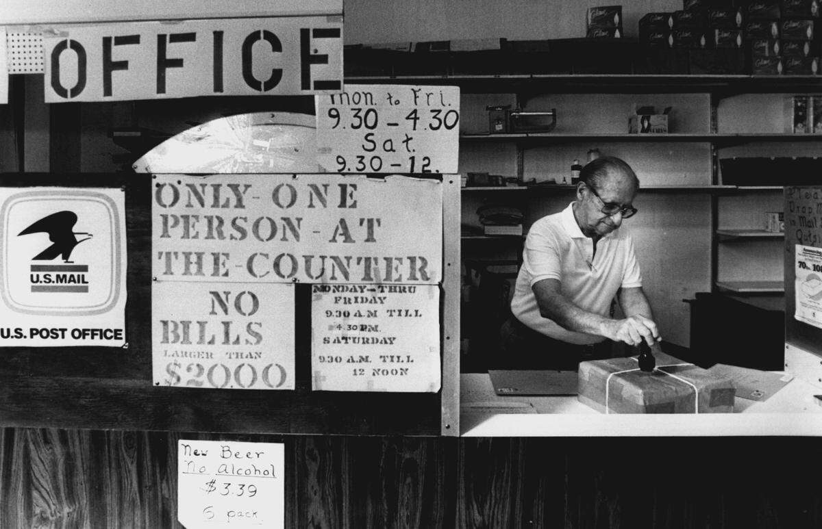 Edward Portillo stamps mail at post office branch inside Federgo Drugs in North Bay Village.