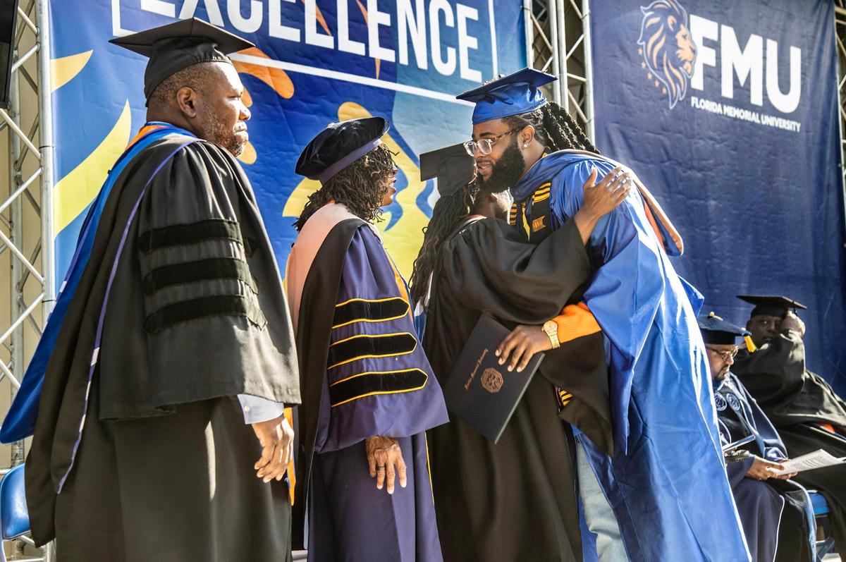 FMU faculty members greet student Perontay Cecil Antonio Fawkes, business graduate, during the spring commencement ceremony at Florida Memorial University in Miami Gardens, on Saturday May 6, 2023.