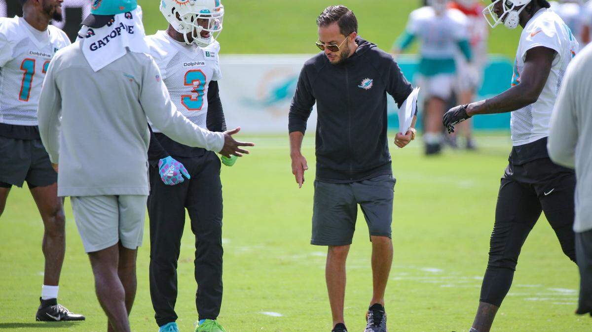 Miami Dolphins head coach Mike McDaniel speaks with wide receiver Lynn Bowden Jr. (3) during practice at Baptist Health Training Complex in Miami Gardens on Friday, July 29, 2022.