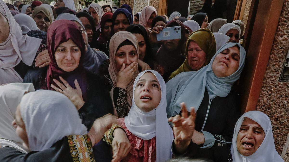 Palestinian women are seen mourning during the funeral of a Palestinian youth who was killed in clashes with Israeli forces near Beita village.