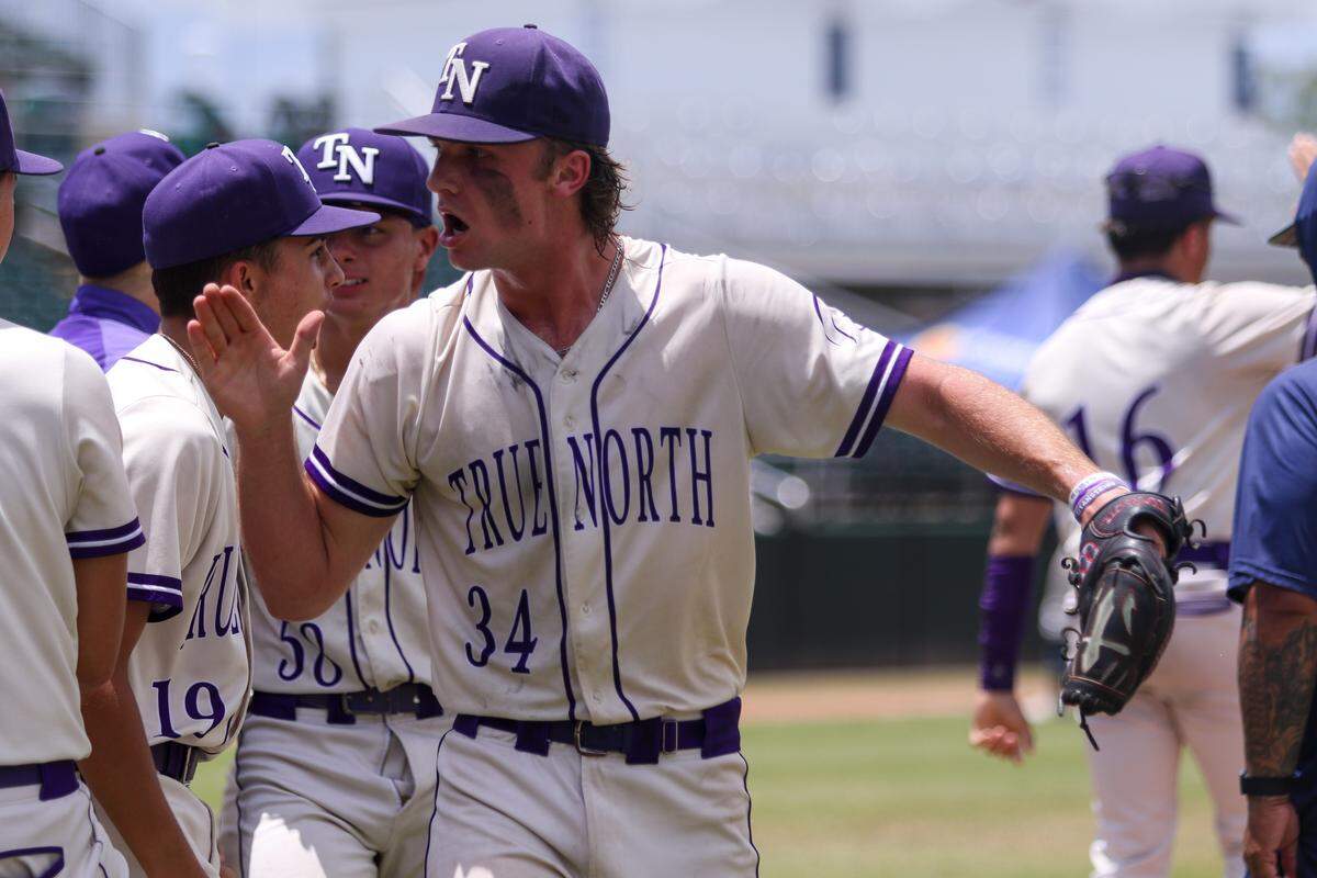True North pitcher Will Foss high-fives teammates after the Titans beat Tampa Berkeley Prep on Monday in a Class 2A state semifinal at Hammond Stadium in Fort Myers, Fla.