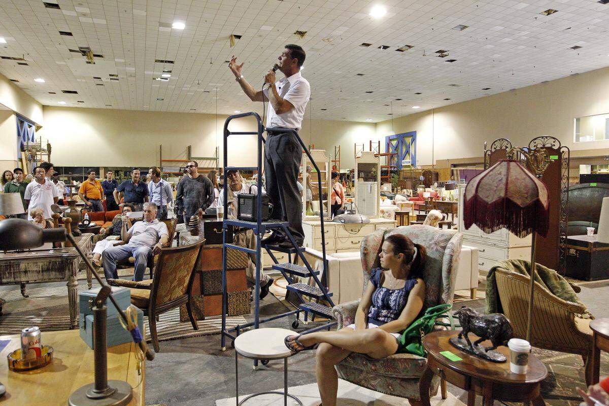 Scott Grasso begins the bidding wars as Burn Notice began auctioning off the props from its spy series on Tuesday morning, Aug. 27, 2013 at the Coconut Grove Convention Center.