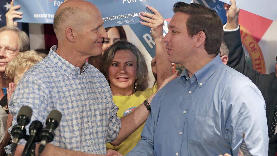 Florida Gov. Rick Scott, left, shakes hands with gubernatorial candidate Ron DeSantis as he introduces him to supporters at a Republican rally Thursday, Sept. 6, 2018, in Orlando. Scott is trying to unseat Democratic U.S. Sen. Bill Nelson.