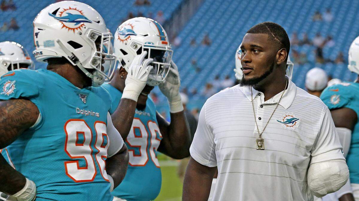 An injured Miami Dolphins defensive tackle, Kendrick Norton, watches the team practice before the Miami Dolphins host the Atlanta Falcons at Hard Rock Stadium in Miami Gardens on Thursday, August 8, 2019.