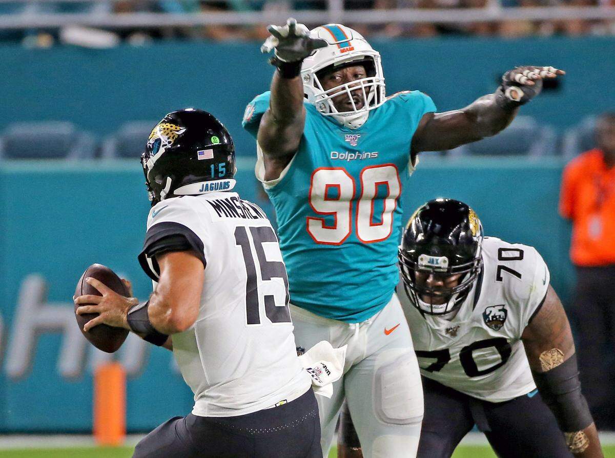 Miami Dolphins defensive end Charles Harris (90) puts pressure on Jacksonville Jaguars quarterback Gardner Mishew (15) in the second quarter at Hard Rock Stadium in Miami Gardens, Florida, Thursday, August, 22, 2019.