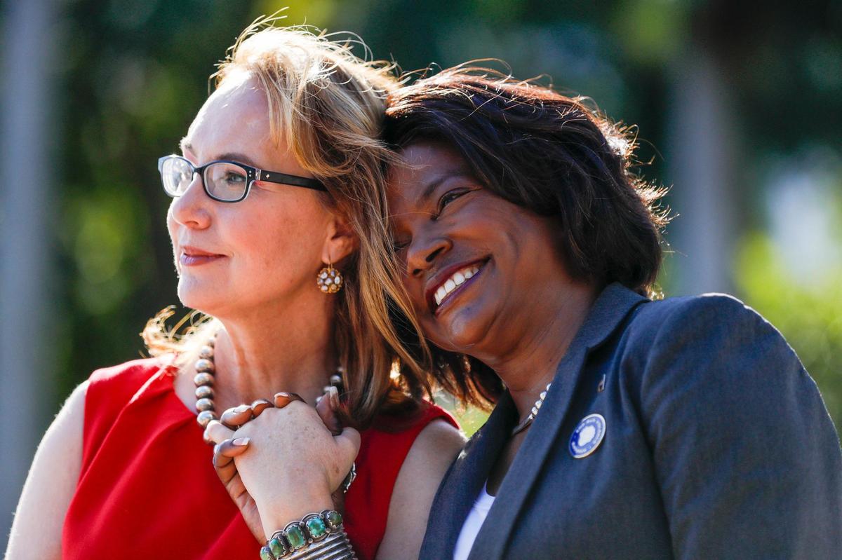 U.S. Rep. Val Demings, right, holds hands with former Congresswoman Gabrielle Giffords at the unveiling ceremony of the Gun Violence Memorial Installation by Giffords PAC at Bayfront Park in downtown Miami on Monday. During the event, Giffords PAC endorsed Val Demings in her campaign for U.S. Senate.