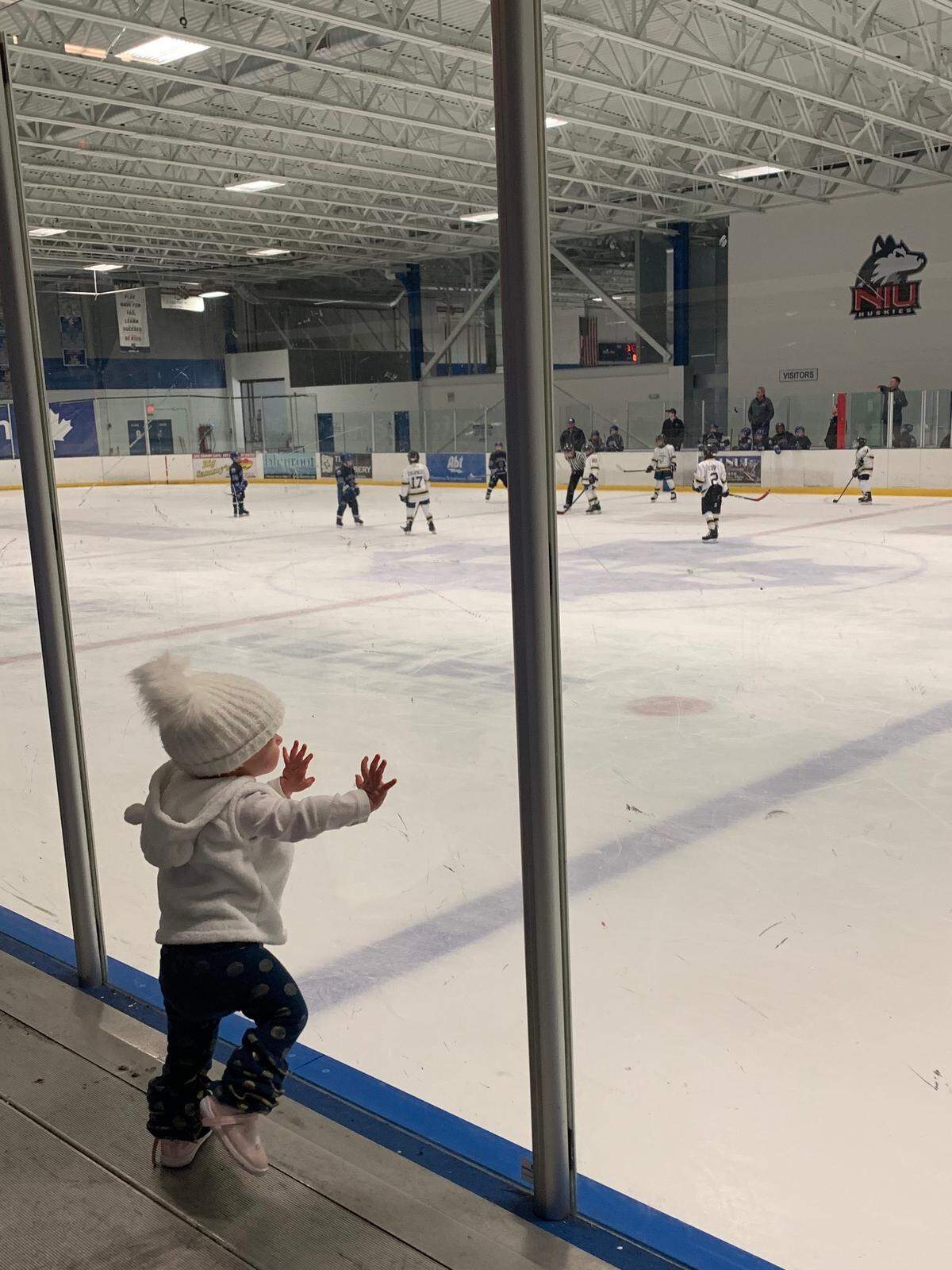 Chloe Wiegand at the glass while her brother plays in a youth hockey game at Canlan Ice Sports in West Dundee, Illinois. Attorney Michael Winkleman said Chloe was trying to bang on the windows bordering the Freedom of the Seas’ H2O Zone the way she does the glass at hockey games when she fell through an open window.