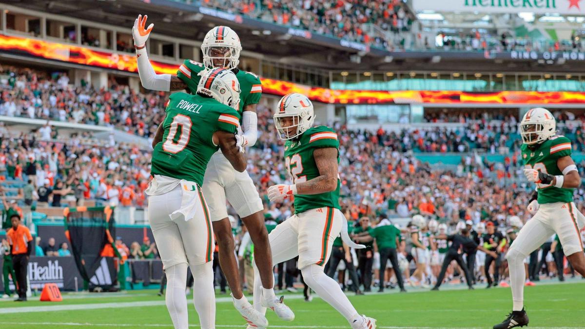 Miami Hurricanes defensive back Mishael Powell (0) celebrates with teammates after scoring on an interception against the Wake Forest Demon Deacons in the first half of their NCAA game in Miami Gardens, Florida, on Saturday, November 23, 2024.