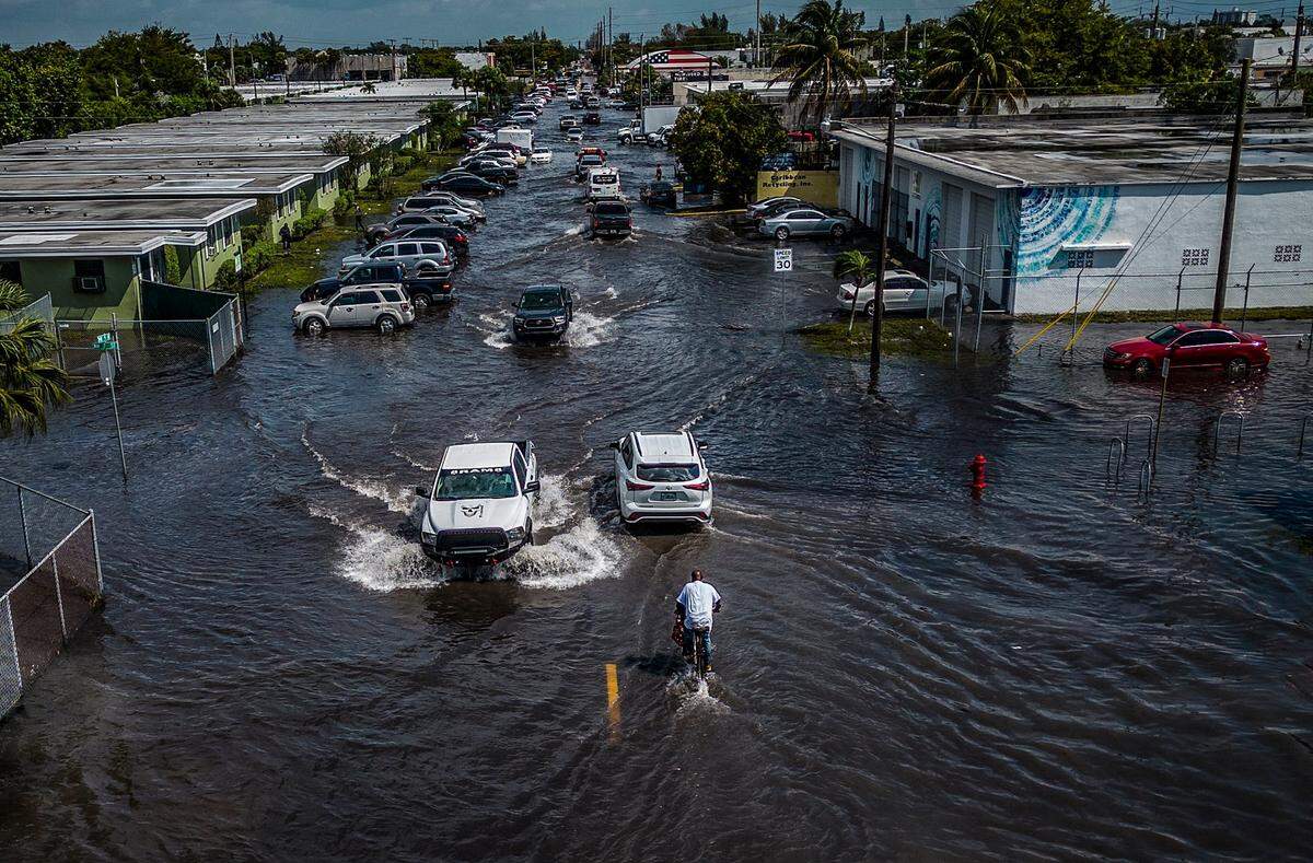 Cars gets trough the waters at the interception of 7 Street NW15th Ave as many streets in the Fort Lauderdale remained flooded due to the heavy rain that affected Broward County for the last two days, on Thursday April 13, 2023.