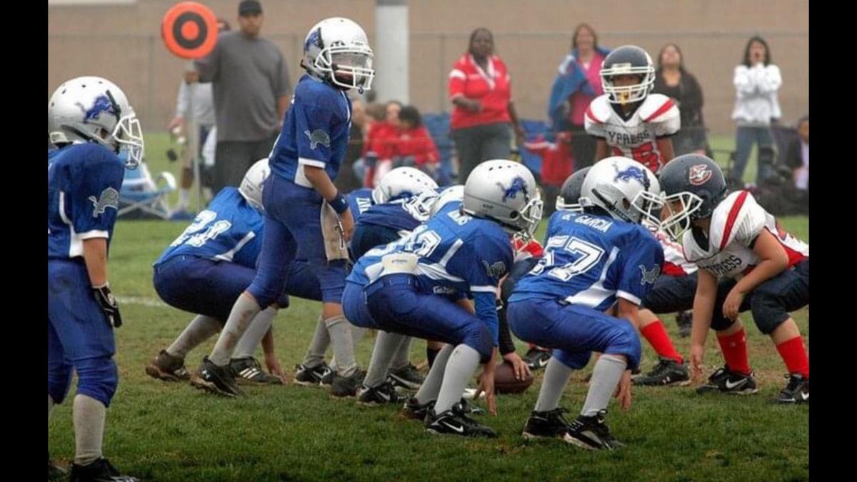 Quarterback Jake Garcia, who signed with the Miami Hurricanes’ recruiting class of 2021, is shown as a 9-year-old under center for his Pop Warner team.