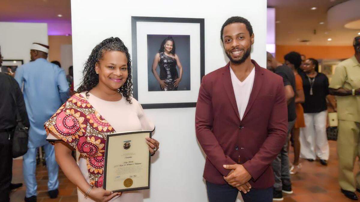 Misty X. Brown, chief of staff for Miami-Dade County Commission Chairwoman Audrey M. Edmonson,
stands in front of the photograph of herself that was taken by the exhibit photographer, Joe Wesley.  The county’s Black Advisory Board put on an exhibit recognizing the black community’s contributions to the county, entitled, “Vessels 2019: Women of Substance” and “Triumphant Spirits 2019: African American Men.”
