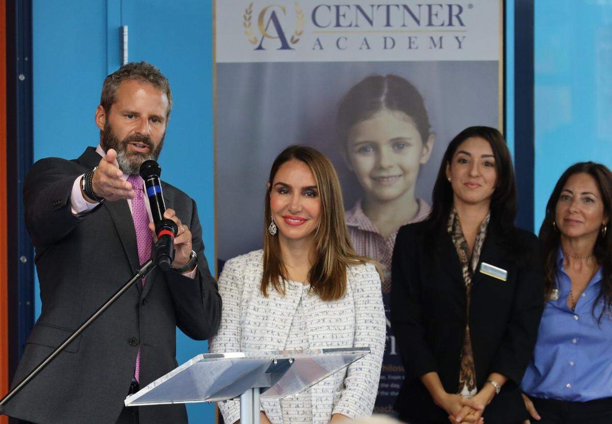 David Centner (left) and his wife Leila (center) greet attendees during a preview of the school in Miami’s Design District in 2019.