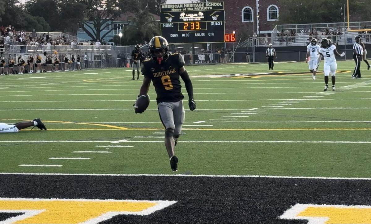 American Heritage receiver Jamar Denson runs into the end zone on a 41-yard touchdown reception during Friday night’s 51-12 win over Western at American Heritage.