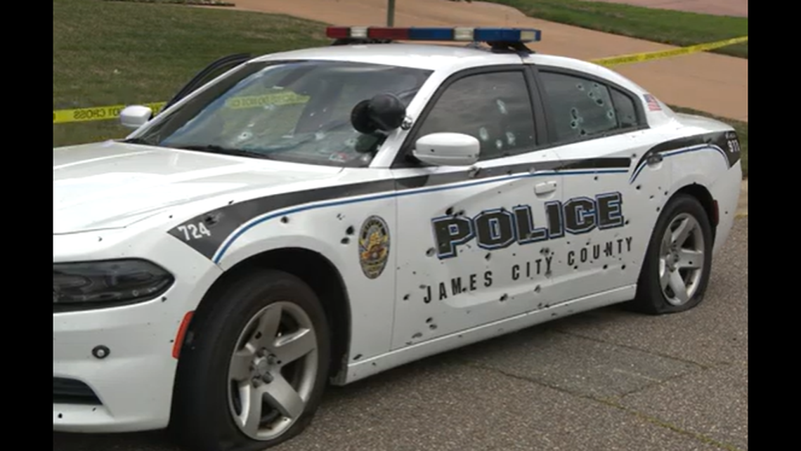 One officer flatted himself against the curb on the other side of the patrol car as it was being hit by shots, officials said.