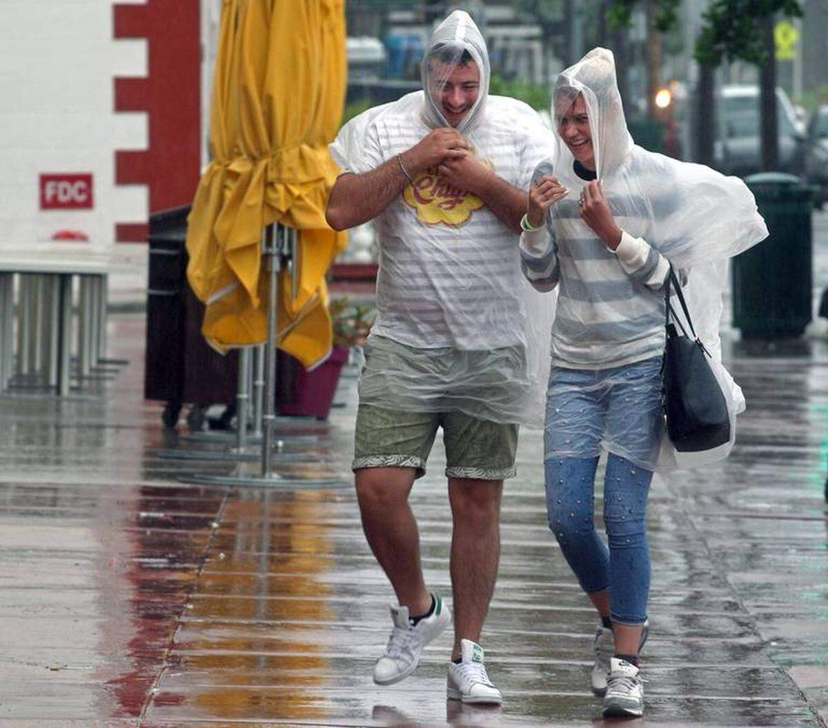 South Beach tourists brave the bad weather as a tropical storm warning was issued for coastal Miami-Dade County.