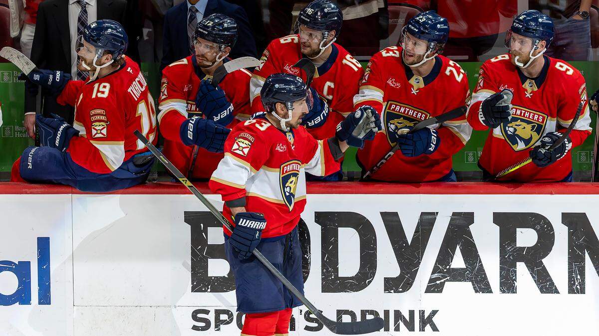 Florida Panthers center Brad Marchand (63) celebrates with teammates Matthew Tkachuk (19), Evan Rodrigues (17), Aleksander Barkov (16), Carter Verhaeghe (23), and Sam Bennett (9) after scoring in the third period of Game 3 of the Eastern Conference Final against the Carolina Hurricanes at Amerant Bank Arena on Saturday, May 24, 2025, in Sunrise, Fla.