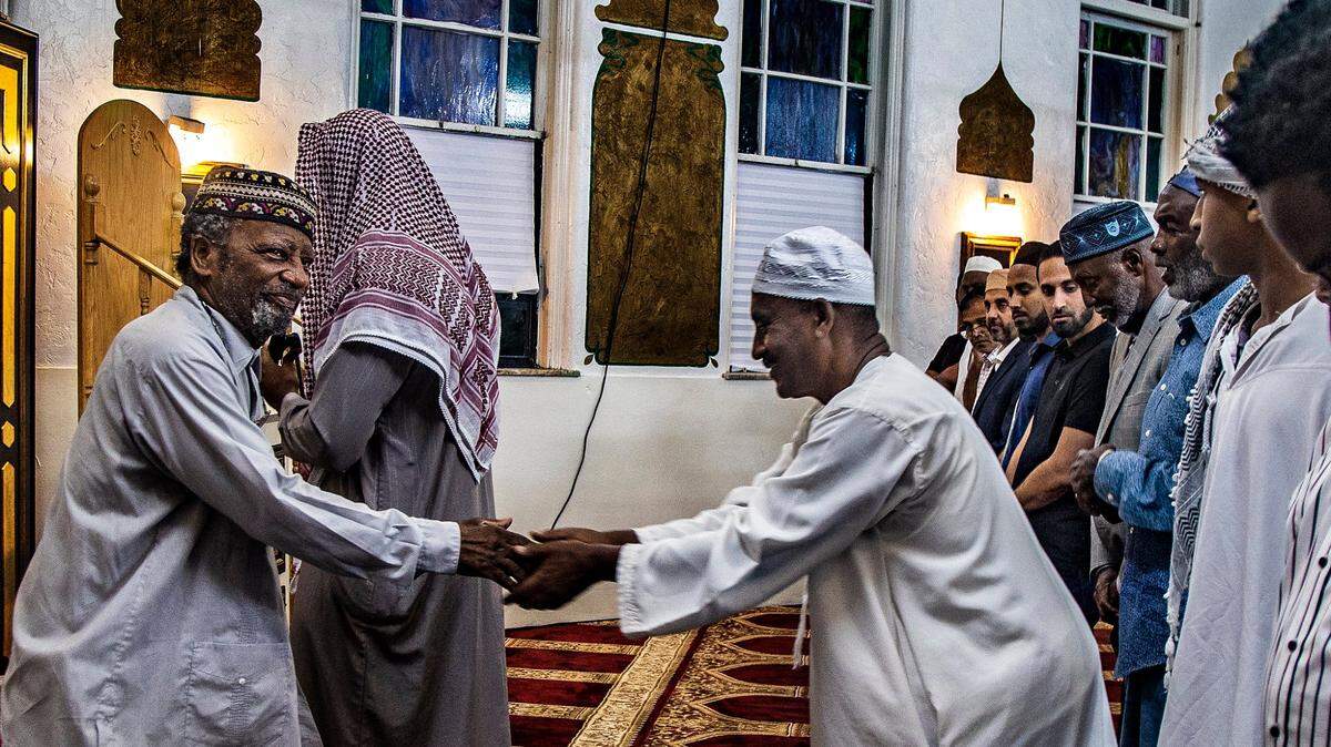 Imam Nasir Ahmad, greets attendees during the “Maghrib Prayer” as part of the Ramadan Open House Iftar at Masjid Al-Ansar in Miami. Masjid Al-Ansar is one of the oldest mosques in South Florida, that serves as a religious center for the Islamic community. on Thursday April 06, 2023.