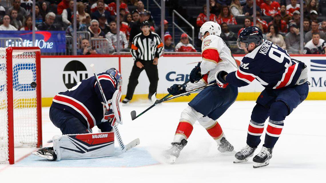 Nov 8, 2023; Washington, District of Columbia, USA; Florida Panthers center Sam Reinhart (13) scores the game winning goal on Washington Capitals goaltender Darcy Kuemper (35) as Capitals center Evgeny Kuznetsov (92) defends in overtime at Capital One Arena.
