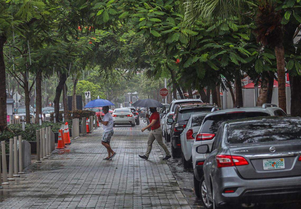Pedestrians navigated the rainy and windy streets of Midtown as Tropical Storm Eta picked up strength on Nov. 8, 2020, as it moved over Cuba and the Florida Straits.