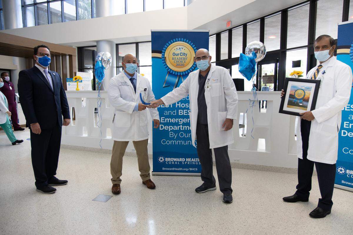 Dr. Israel Penate, chief of staff for Broward Health Coral Springs, second from left, celebrates the hospital’s selection as the best hospital and emergency department presented by Our City Readers’ Choice. From left: Jared Smith, CEO of Broward Health Coral Springs, Dr. Gary Lai, medical director of the Emergency Department, Dr. Penate, and Dr. Kutty Chandran, chief medical officer for Broward Health Coral Springs.