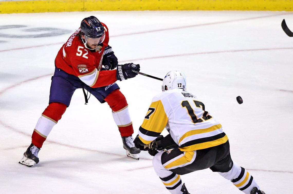 Florida Panthers defenseman MacKenzie Weegar (52) passes the puck against Pittsburgh Penguins right wing Bryan Rust (17) during the second period of the Florida Panthers NHL home opener game at the FLA Live Arena on Thursday, October 14, 2021 in Sunrise, Fl.