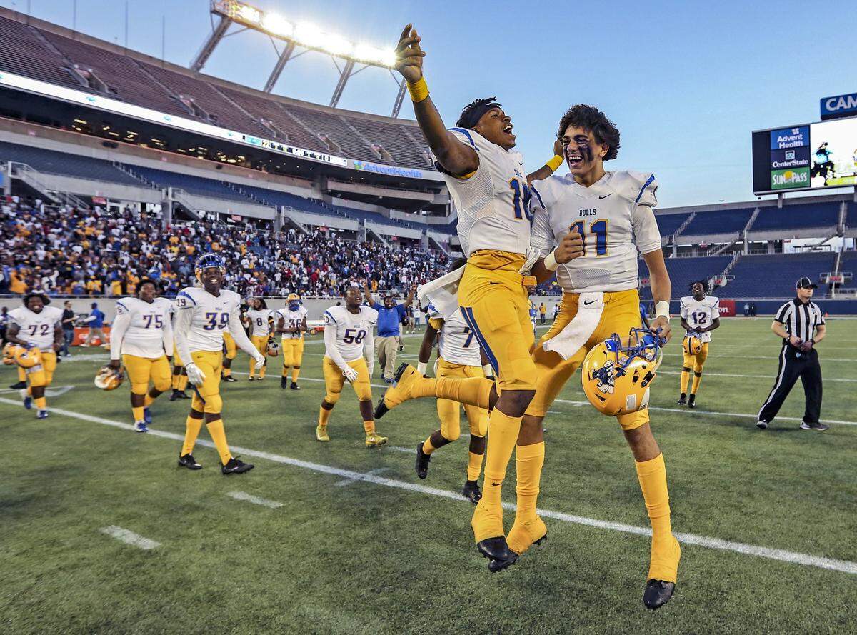 The Bulls’ Kahlil Brantley (18) and Isiah Velez (11) celebrate after Miami Northwestern defeats Armwood Hawks during the Florida High School Athletic Association State Championship Class 6A Saturday, Dec. 8, 2018, at Camping World Stadium in Orlando.