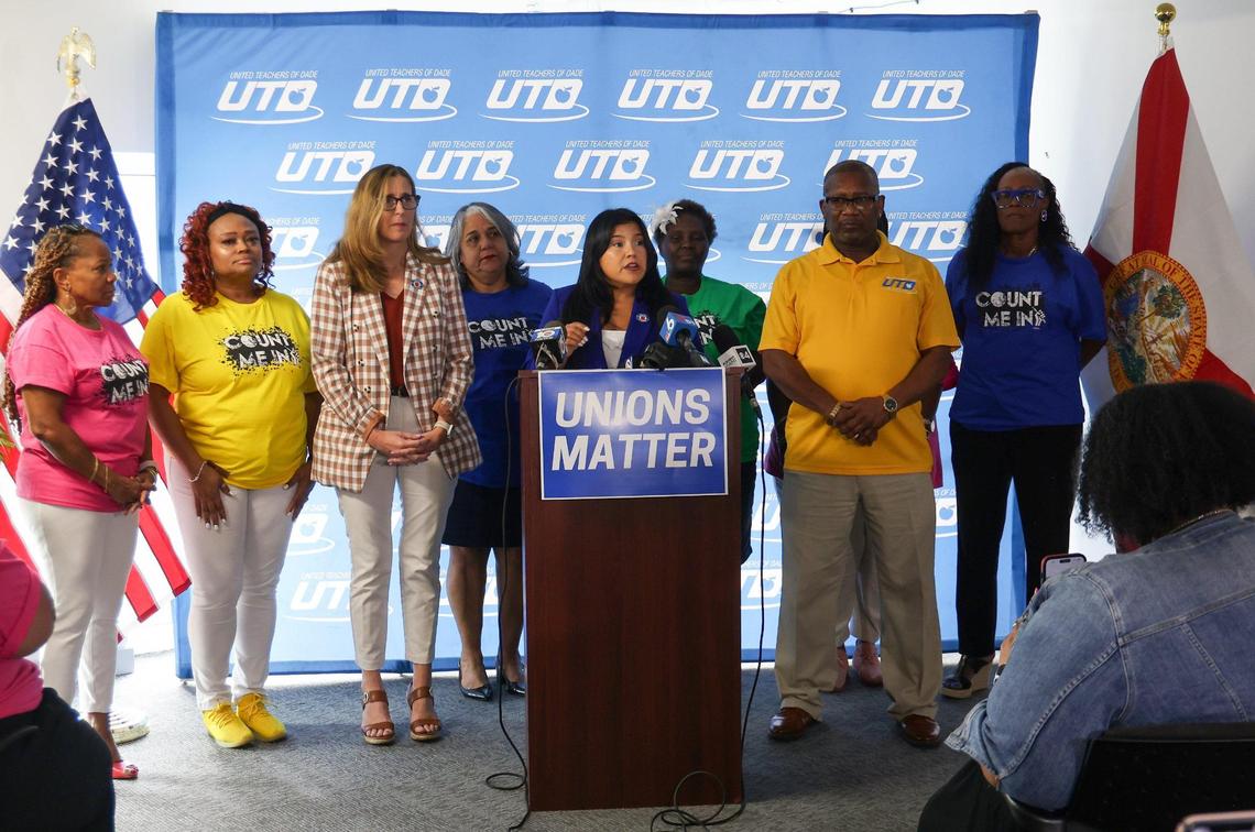 United Teachers of Dade (UTD) President Karla Hernández-Mats, center, flanked by union members, discusses the union’s new contract with Miami-Dade County Schools, which calls for raises between 7 and 10 percent for teachers in the coming school year, at the UTD office on Thursday, July 27, 2023 in Miami, Florida.