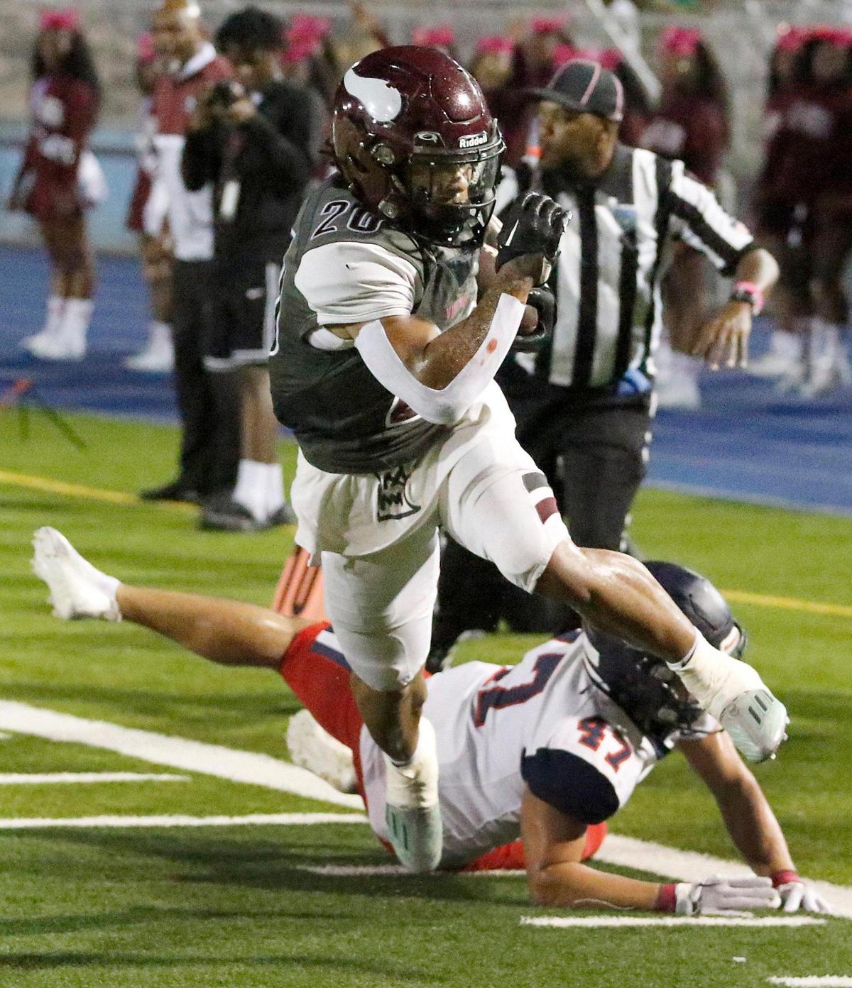 Norland Vikings running back Juan Rodriguez (20) escapes a tackle by Columbus Explorers defender during the football game on Friday, October 20, 2023 at Traz Povewll Stadium in Miami. Andrew Uloza / for Miami Herald