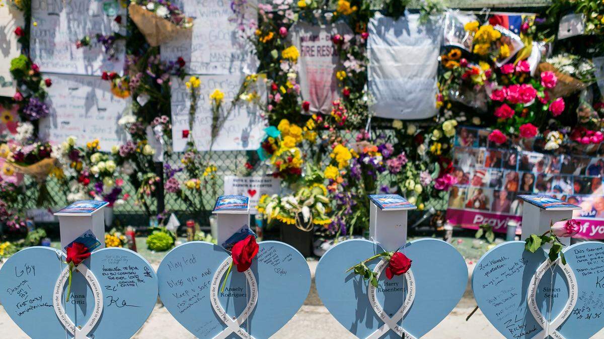 Makeshift markers adorn the Surfside Wall of Hope & Memorial as rescue teams continue their recovery mission at the collapsed Champlain Towers South Condo building in Surfside, Florida on Friday, July 9, 2021.