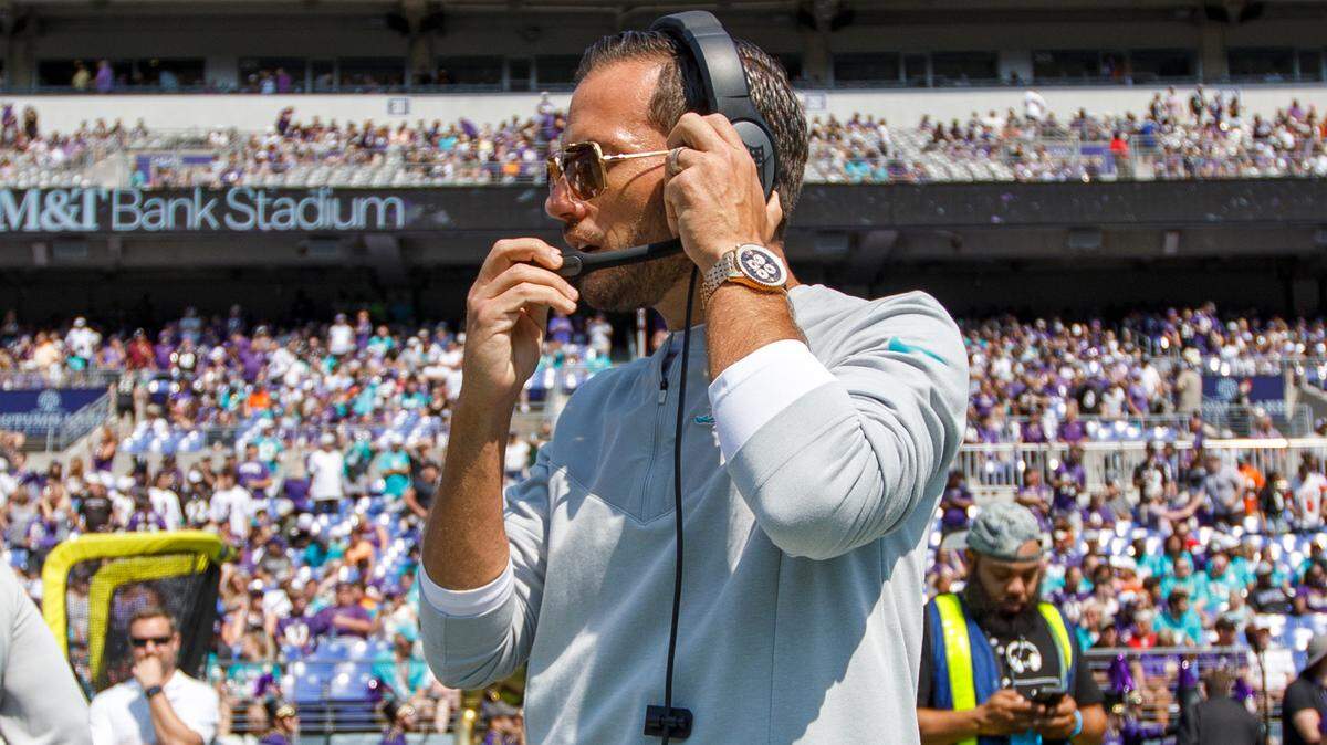 Miami Dolphins head coach Mike McDaniel adjusting his headset before the start of an NFL football game against the Baltimore Ravens at M&T Bank Stadium on Sunday, September 18, 2022 in Baltimore, MD.
