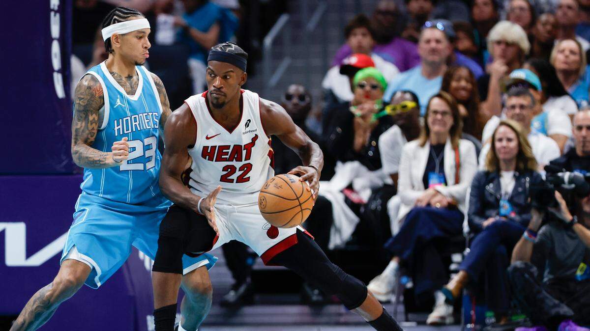 Miami Heat forward Jimmy Butler (22) drives into Charlotte Hornets guard Tre Mann (23) during the second half at Spectrum Center.