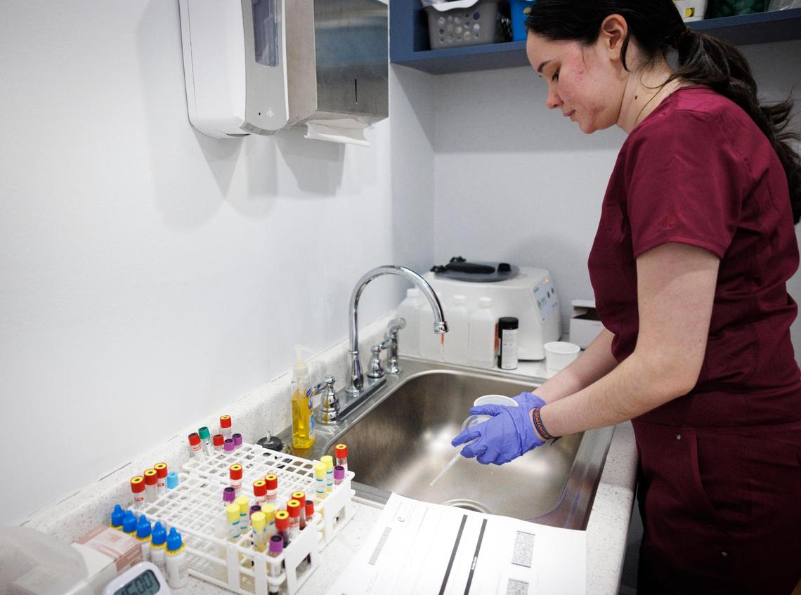Brianna Ulloa, medical assistant who works part time at the clinic, works in the lab during the day on Monday, Dec. 16, 2024, inside the UHI CommunityCare Clinic in Opa-locka, Fla.