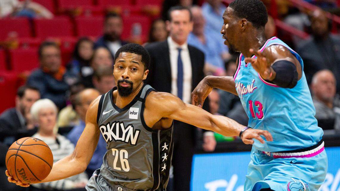 Brooklyn Nets point guard Spencer Dinwiddie (26) dribbles past Miami center Bam Adebayo (13) during the second quarter of an NBA basketball game against the Heat at the American AirlinesArena in Miami on Saturday, February 29, 2020.