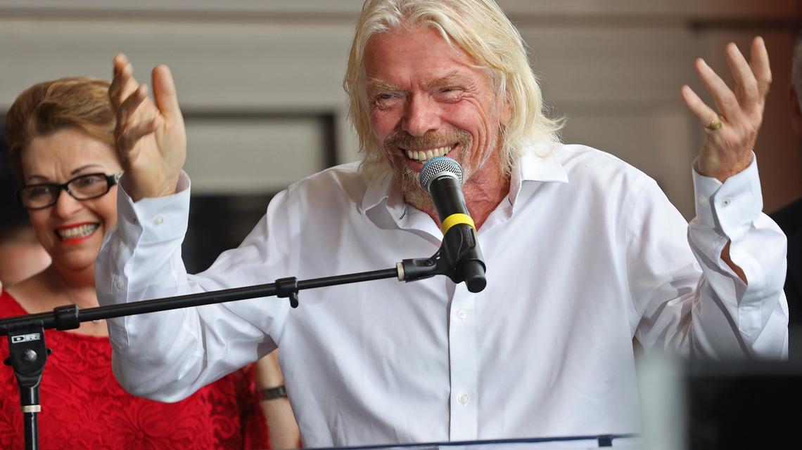 Richard Branson stands among city and county officials as he makes his remarks prior to unveiling the new name for the downtown Miami’s transportation hub, “Virgin MiamiCentral”, in downtown Miami, Florida on April 4, 2019.