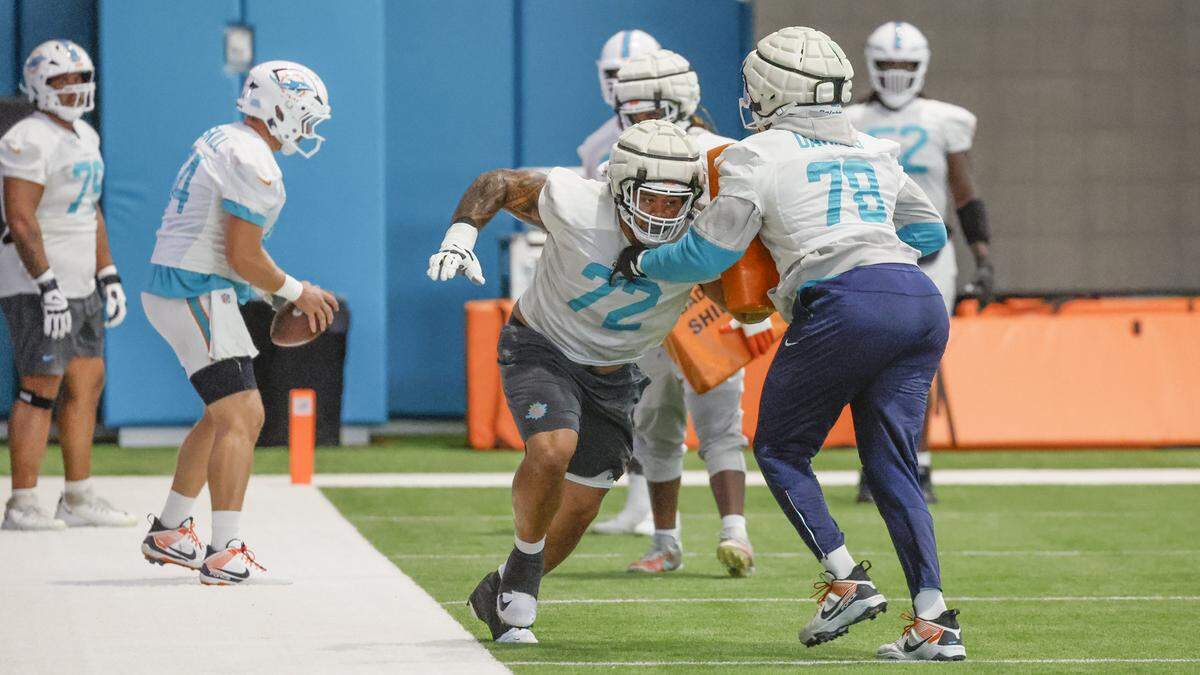 Miami Dolphins guard Jonah Savaiinaea (72) and guard James Daniels (78) run practice drills at the Miami Dolphins Training Camp in Miami Gardens, Florida, on Tuesday, August 26, 2025.