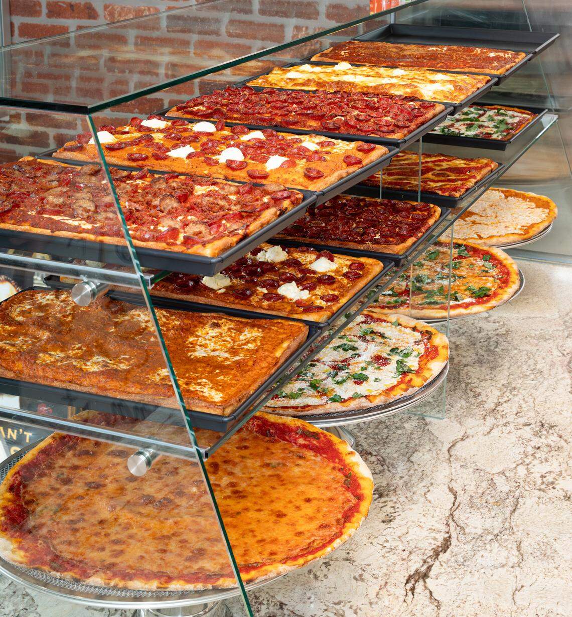 Prince Street Pizza sells square and circular pies by the slice.