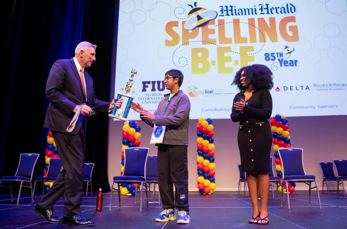 Nikhil Sha, a seventh grader from Palmetto Middle School, receives the first place trophy from Miami Herald, el Nuevo Herald and Bradenton Herald general manager, Bob McFarlin, after winning the 85th Miami Herald Spelling Bee for Miami-Dade and Monroe County at the Charles F. Dodge City Center on Wednesday, Feb. 26, 2025, in Pembroke Pines, Fla.