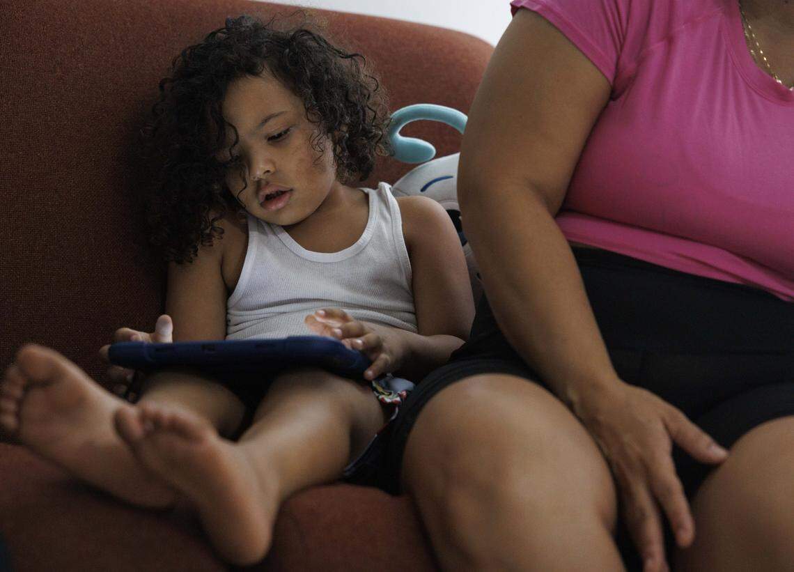 Alex Tejada, 4, who has autism, plays on his tablet during the afternoon on Wednesday, Oct. 29, 2025, in Overtown.