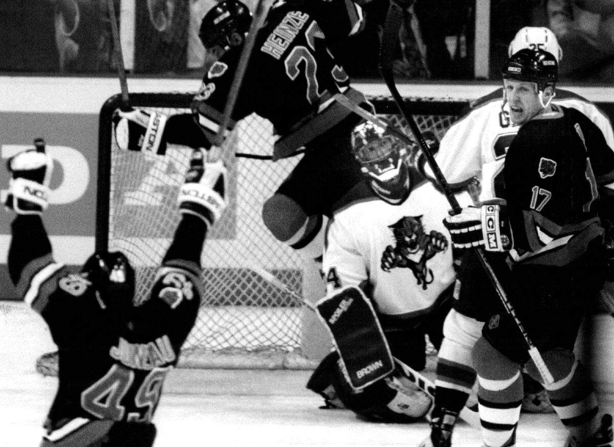 Florida Panthers goalie John Vanbiesbrouck watches as Boston Bruin Joe Juneau celebrates his overtime goal at Miami Arena, Dec. 19, 1993, the Panthers’ inaugural season. Panthers center Stu Barnes scored with six seconds left in the third to send the game into overtime before Juneau scored for a 2-1 Boston win.