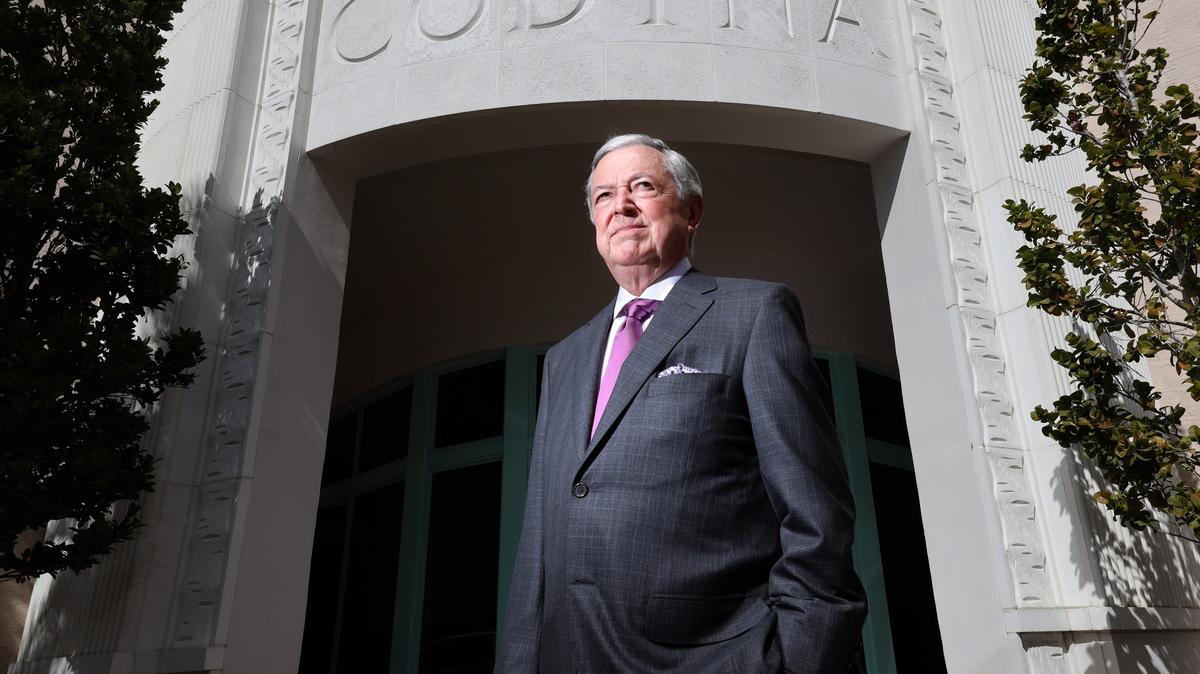 Developer Armando Codina stands at the entrance to the office and apartment complex he built in downtown Coral Gables.