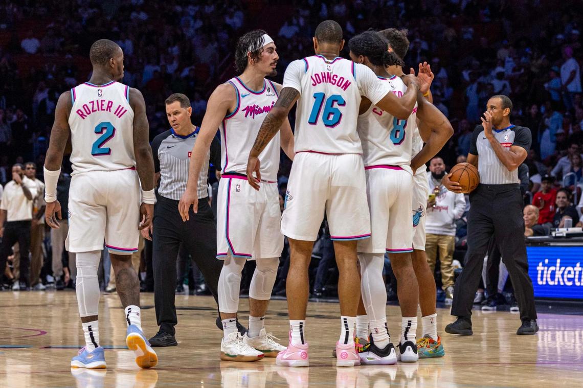 Miami Heat players Terry Rozier (2), Jaime Jaquez Jr. (11), Keshad Johnson (16), Josh Christopher (8) and Kyle Anderson (20) huddle up during the second half of an NBA game against the Washington Wizards at Kaseya Center on Sunday, April 13, 2025, in Miami, Fla.
