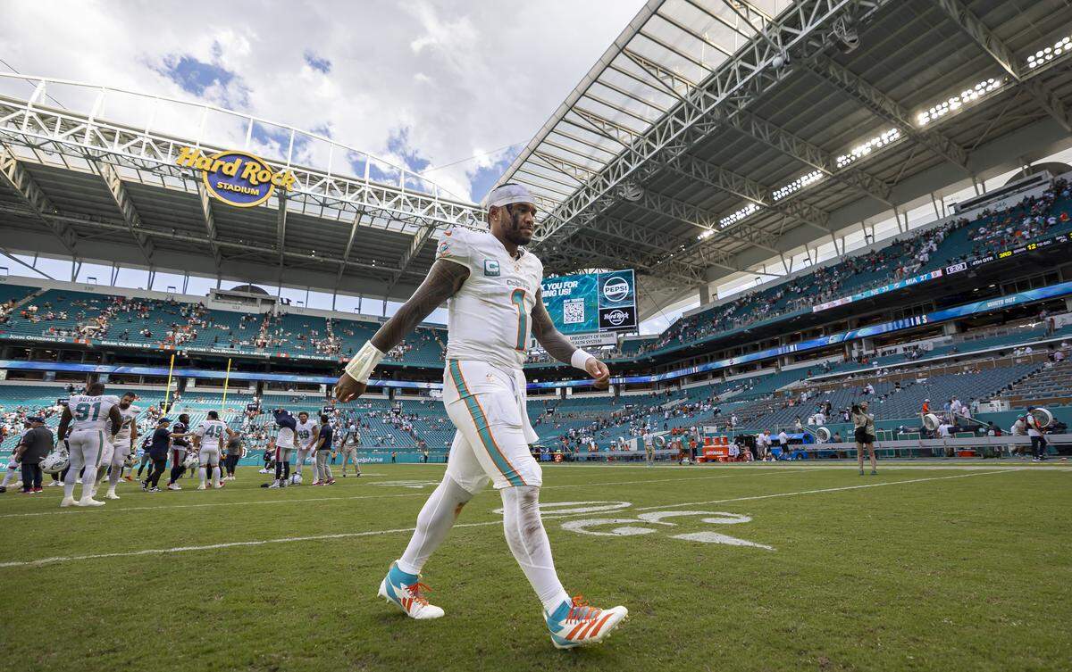 Miami Dolphins quarterback Tua Tagovailoa (1) walks off the field after losing against the New England Patriots in the second half of their NFL game at Hard Rock Stadium on Sunday, Sept. 14, 2025, in Miami Gardens, Fla.