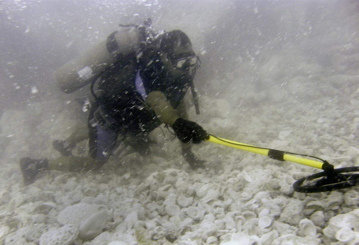 Johan Mora, a member of the salvage crew of the Dare, works the metal detector underwater along the trail of the Nuestra Senora de Atocha shipwreck Wednesday, July 7, 2010, off of Marquesas Keys, Fla. July 20 will mark the 25th anniversary of Mel Fisher find of the $450 million motherlode of the 1622 shipwrecked Atocha. The search continues for the stern castle of the ship, where the church kept its gold and taxes, according to Sean Fisher, Mel’s grandson.