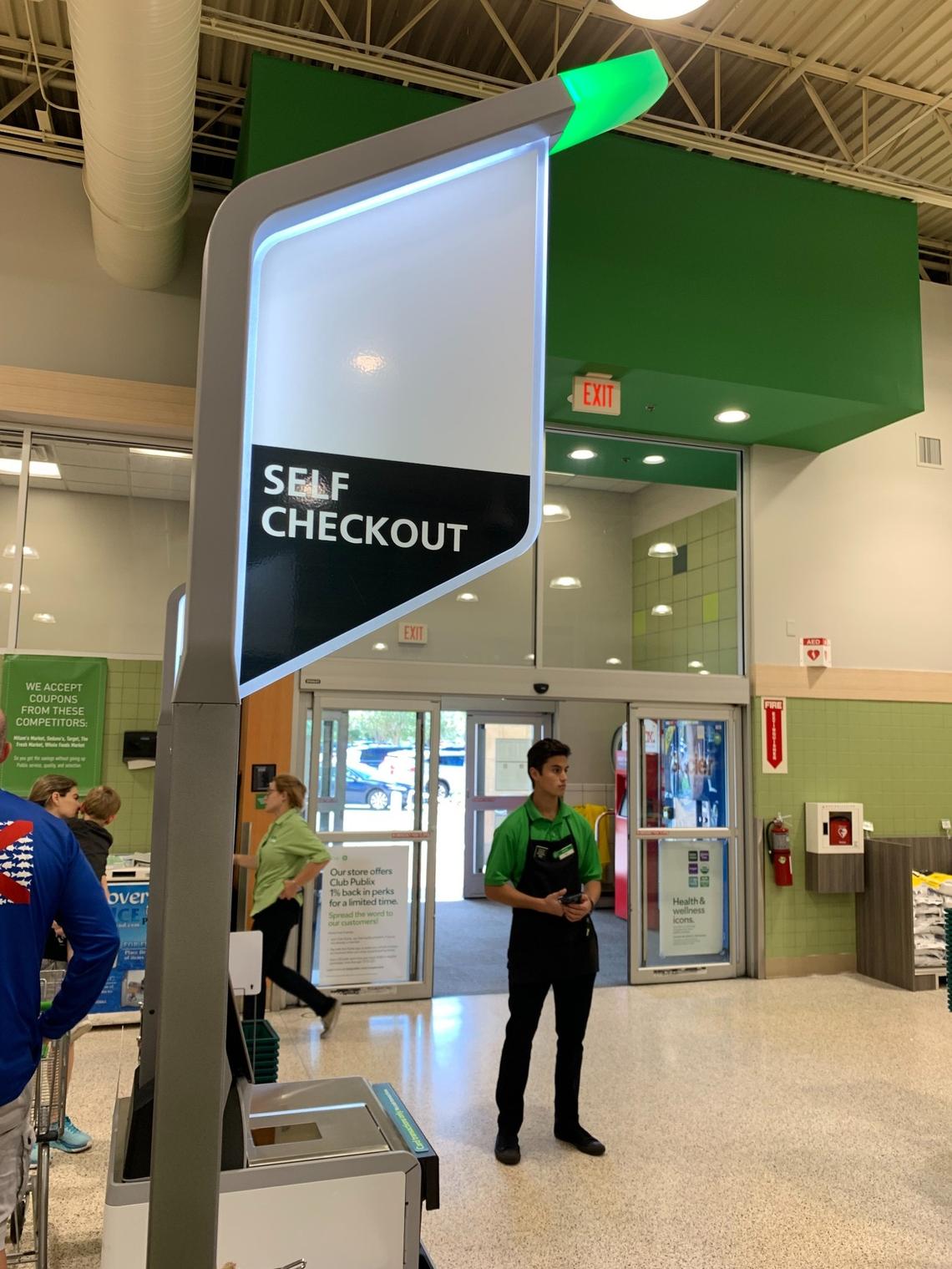 Publix employees still staff self-checkout lanes at stores that offer the option to help customers who may run into problems or need assistance, as at this Pinecrest location on Oct. 2, 2022.