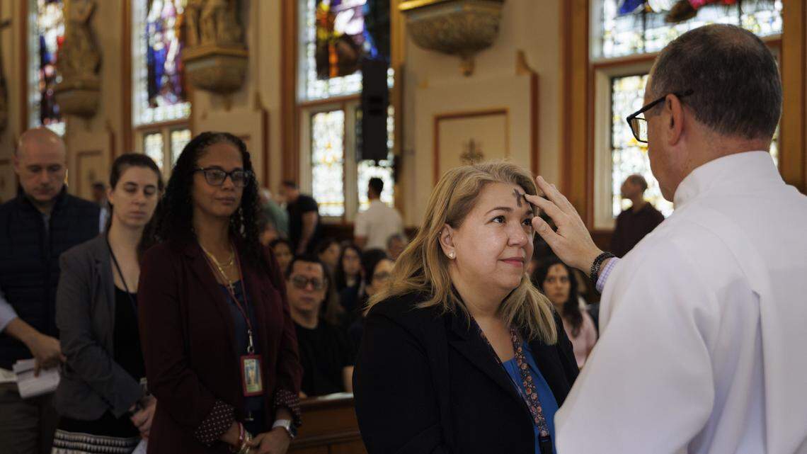 A parishioner receives ashes from a Deacon during Ash Wednesday mass on Wednesday, Feb. 18, 2026, at Gesu Catholic Church in downtown Miami. The mass was fully packed with standing rom only at the back of the church.
