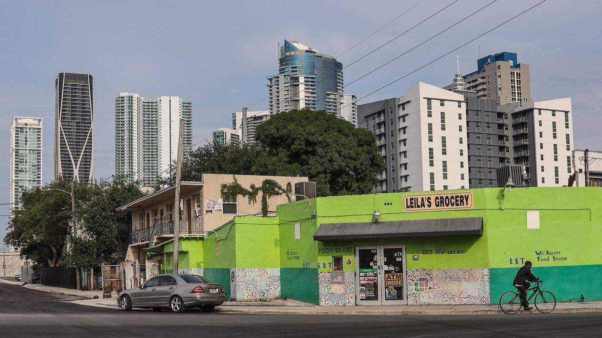 Mom-and-pop stores and small apartment buildings of Overtown, a historically Black neighorhood in Miami, stand in the shadow of new highrises less than a mile away.
