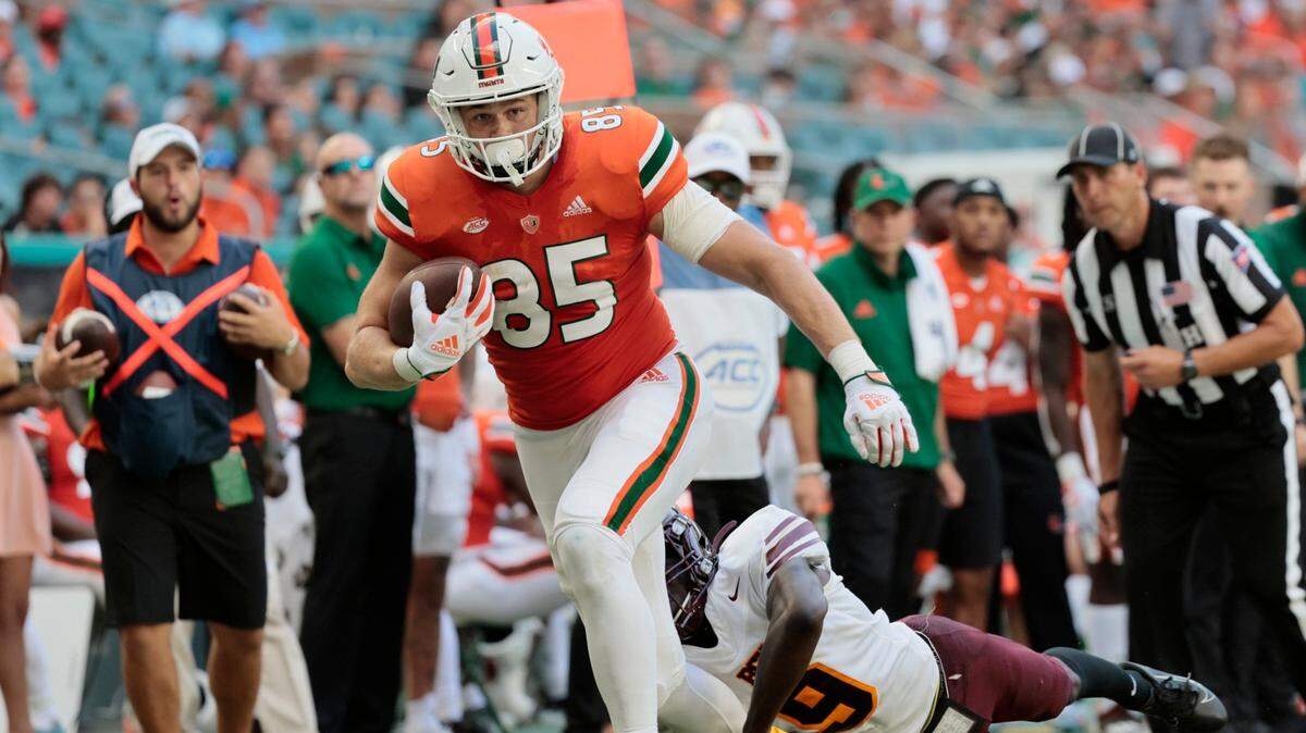 Miami Hurricanes tight end Will Mallory (85) runs to the five yard line for a first down reception as Bethune Cookman Wildcats cornerback Caleb Sutherland (9) defends in the second quarter as at Hard Rock Stadium in Miami Gardens on Saturday, September 3, 2022.