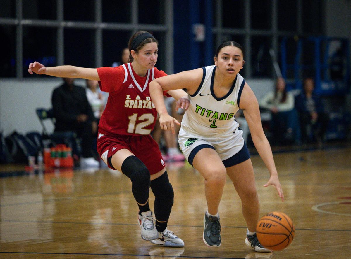 SLAM’s AD Montalvo (2) dribbles passed Monsignor Pace’s Isabel Enriquez (12) during the first quarter of the girls basketball regional semifinal on Monday, Feb. 19, 2024, at SLAM Miami.