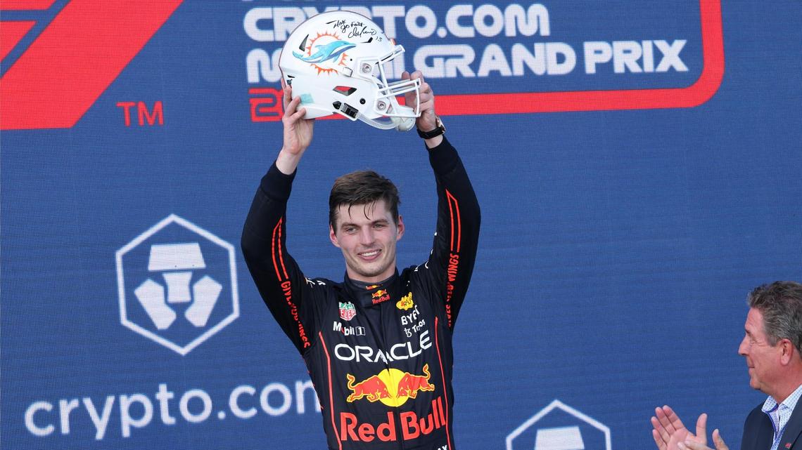 Race winner Red Bull driver Max Verstappen of the Netherlands, lift his gifted signed football helmet given to him by Dan Marino after winning the inaugural Formula One Miami Grand Prix auto race at Miami International Autodrome on Sunday, May 8, 2022 in Miami Gardens, Florida.