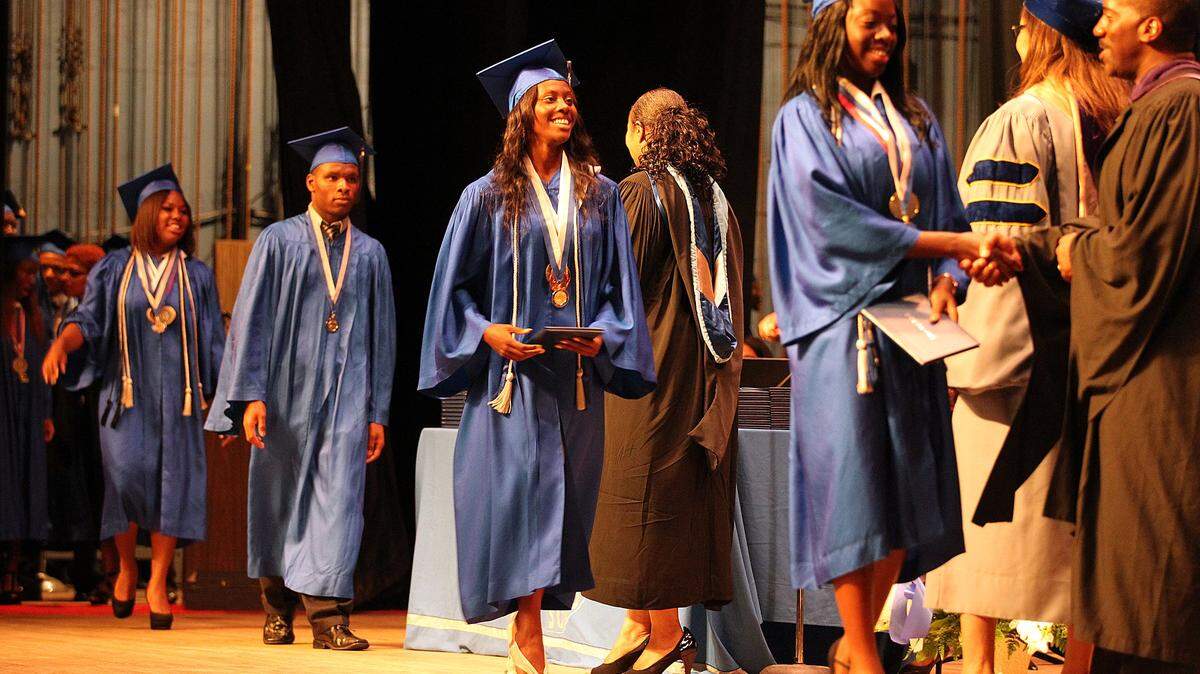 Dillard HS Tiffany Allen gets her diploma at her graduation ceremony at War Memorial Auditorium in Fort Lauderdale, June 4, 2013. In the three years since Broward's school district was singled out in a national study for its awful graduation rate among black male students, the district has made some significant progress in moving the needle. Dillard High School is improving, where black male grad rates are in the high 80s or even low 90s each year - compared to less than 60 percent district-wide.